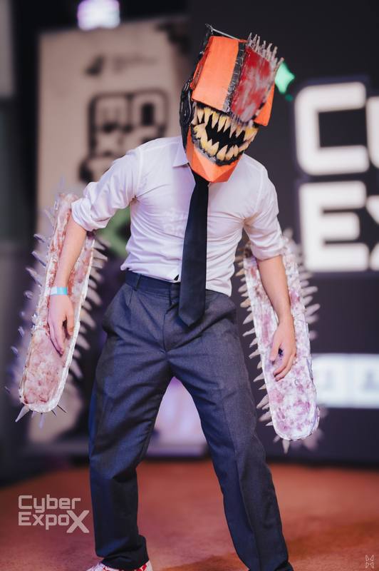 Cosplayer in a chainsaw-arm costume